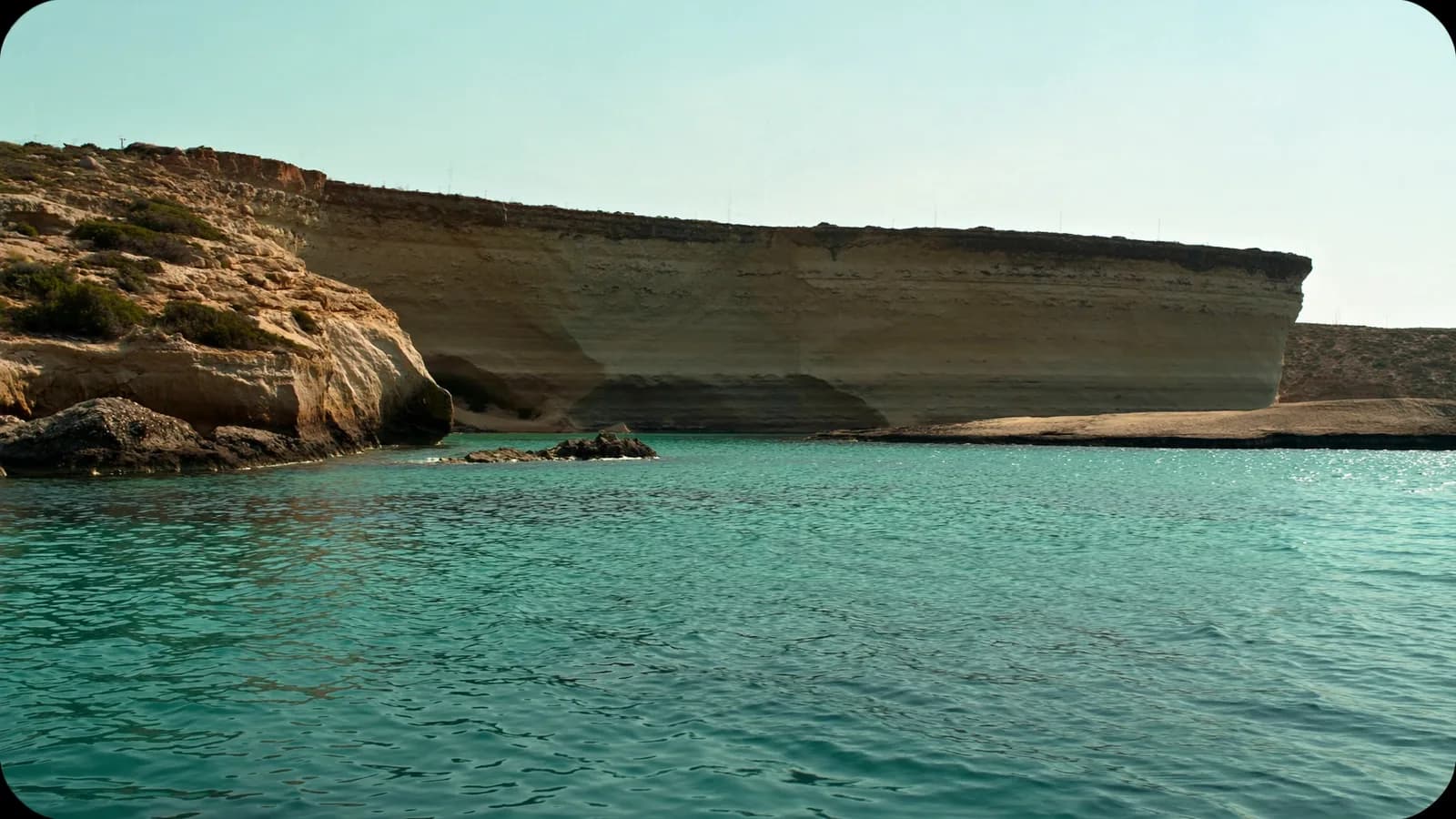 Comino turquoise water and limestone coast in calm light