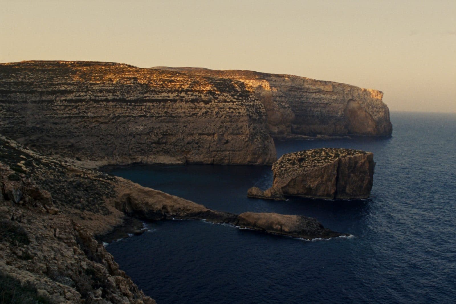 Dwejra on Gozo's west coast at golden hour, with the Inland Sea and Fungus Rock