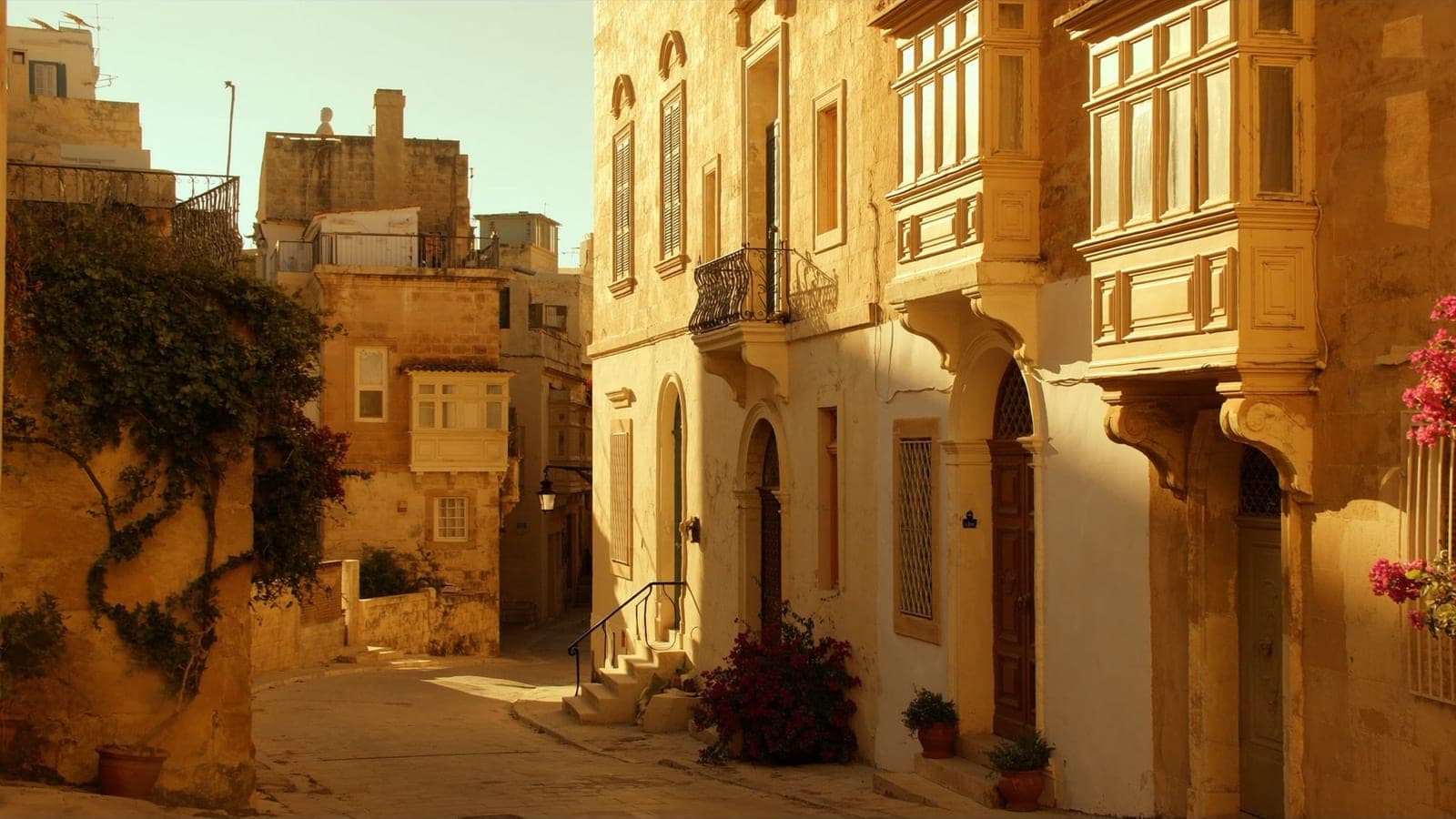 A traditional Maltese old-town street in Mdina at golden hour
